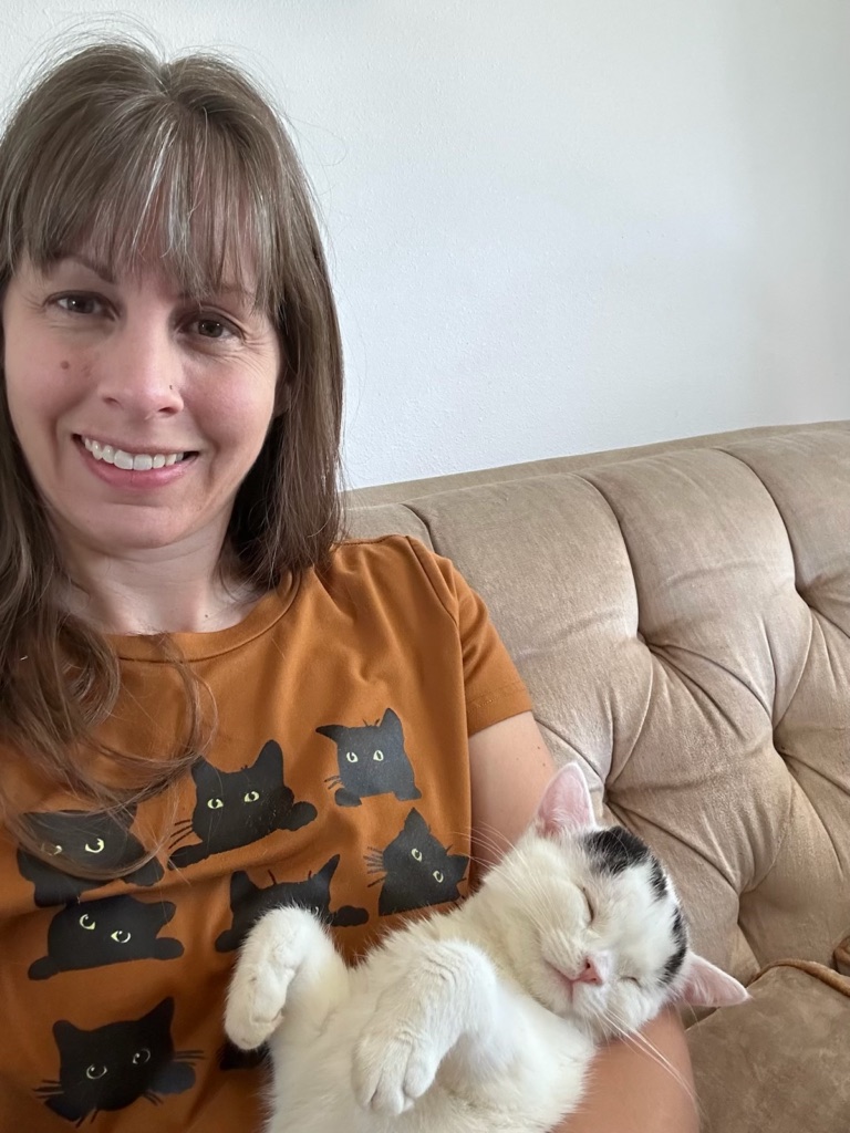 Meka Hilton holding a white and black cat